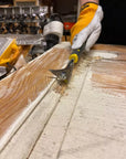 Speedheater Boomerang Scraper used on a door to remove paint in tight grooves and profiles.