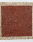 Natural deep red metal primer made from linseed oil and natural pigments. Sample is painted on square swatch of linen.