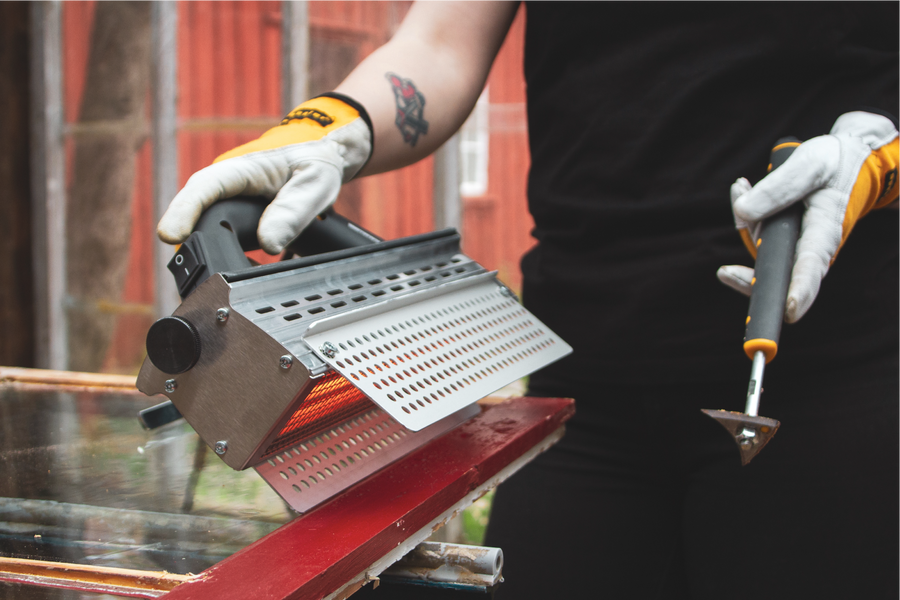 Speedheater Rapid Slim being used on a window in order to quickly and effectively strip old paint off of the wood.