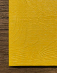 Linseed oil paint for historic preservation. Painted on wood in a bright yellow.