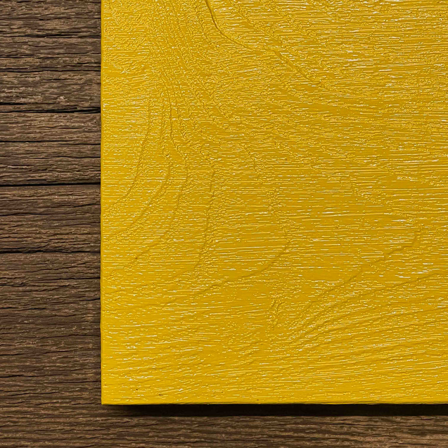 Linseed oil paint for historic preservation. Painted on wood in a bright yellow.