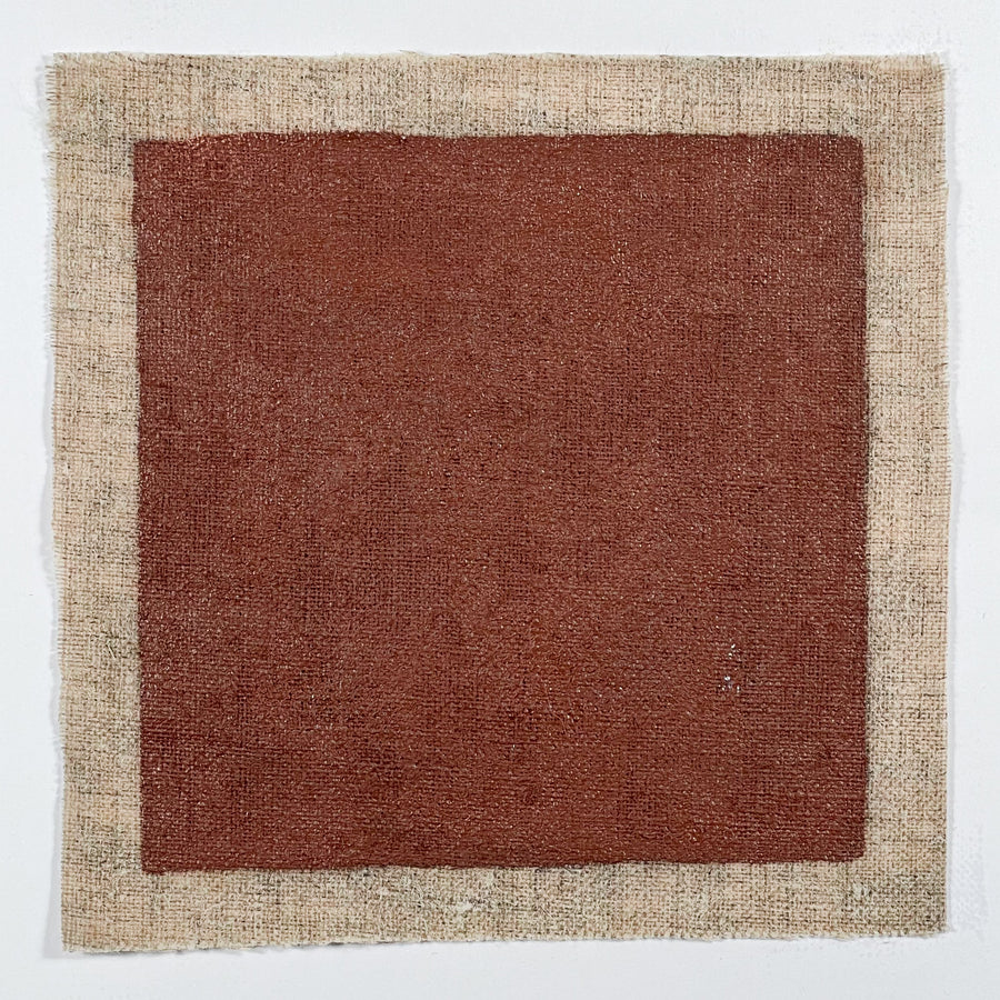 Natural deep red metal primer made from linseed oil and natural pigments. Sample is painted on square swatch of linen. 